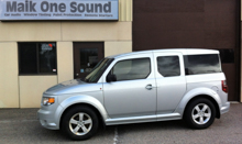 Silver 2011 Honda Element with dark privacy window tint